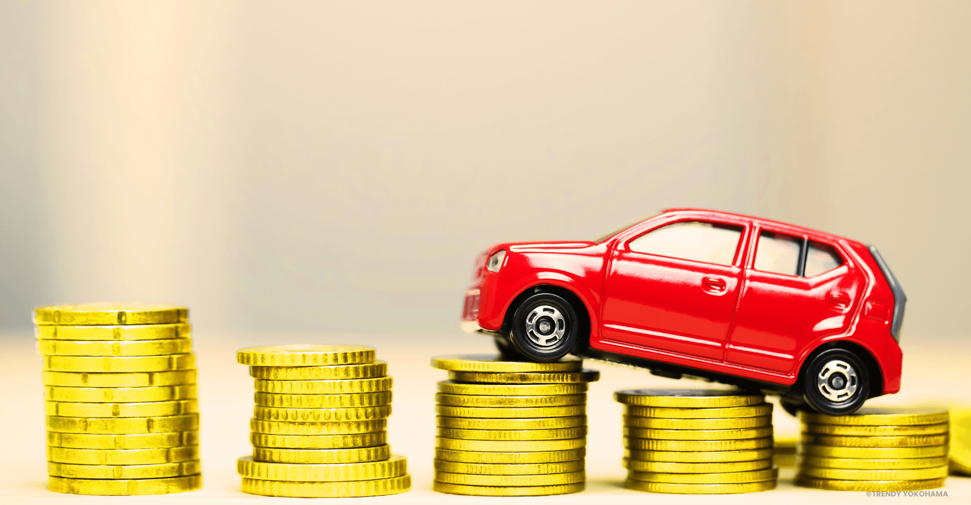 Red car on stacks of coins