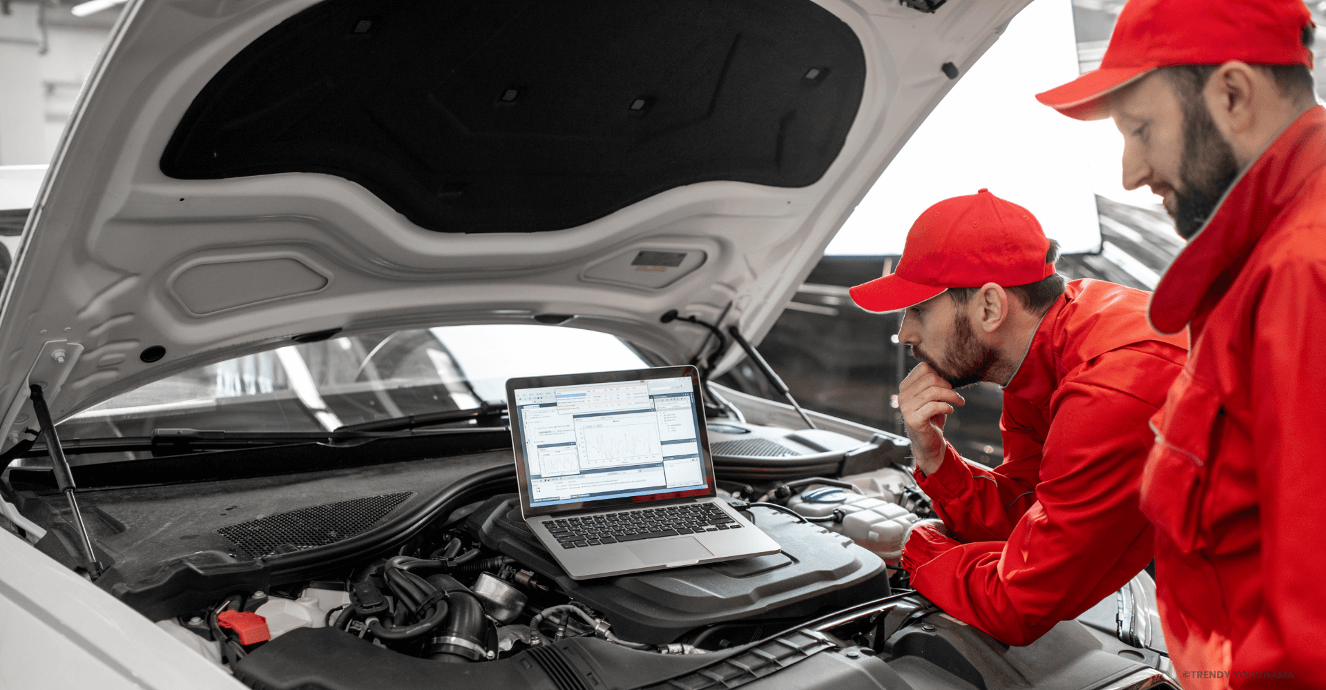 Mechanics inspecting car engine