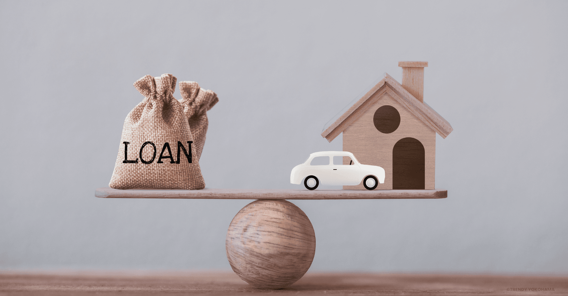 Loan balance concept with house and car